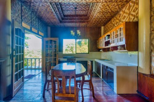 a kitchen with a table and chairs in it at Pilar Pilapil Beach House in Malapascua in Daanbantayan