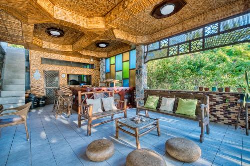 a patio with chairs and a table and a table at Pilar Pilapil Beach House in Malapascua in Daanbantayan