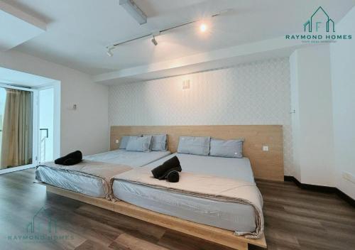 a bedroom with a large bed with two pillows on it at Maritime Sea View Duplex in George Town