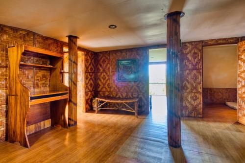 a room with wooden walls and a bench in it at Pilar Pilapil Beach House in Malapascua in Daanbantayan