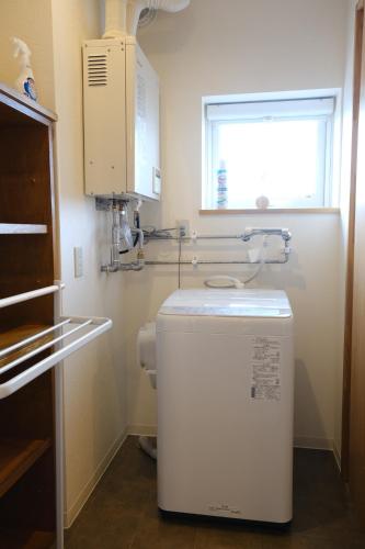 a small refrigerator in a kitchen with a window at Vantean house - Vacation STAY 94009v in Biei