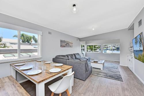 a living room with a table and a couch at Balmoral Waterfront Escape at Lake Macquarie in Balmoral