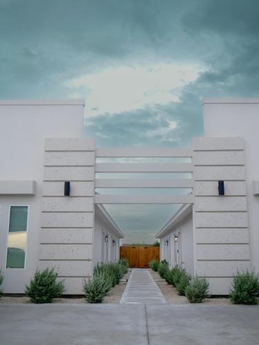 a row of white buildings in a parking lot at Premier Luxe Villa in Weslaco