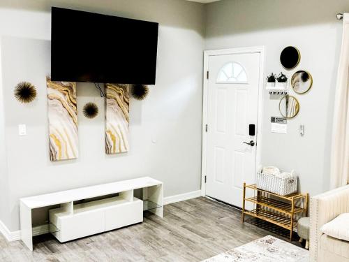 a living room with a tv on the wall at Premier Luxe Villa in Weslaco