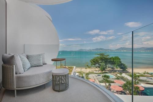 a living room with a couch and a view of the ocean at Veranda Resort Phuket, Autograph Collection in Panwa Beach