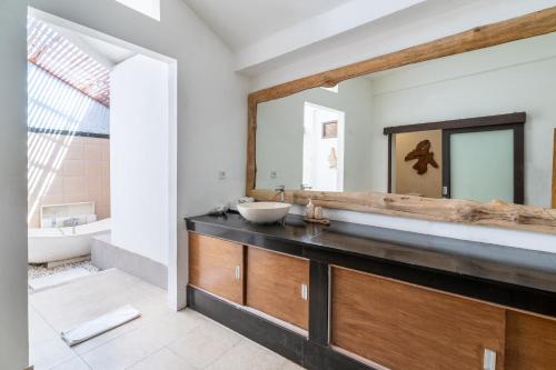 a bathroom with a sink and a mirror at Aveli Villa 5 Bedroom with Pool at Seminyak 5 Mnt To beach by Car in Seminyak