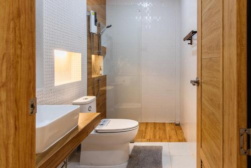 a bathroom with a white toilet and a sink at Turtle Tales-Tahnu,Thaimueang beach,Phang-Nga in Thai Muang
