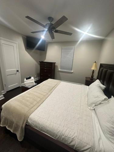 a bedroom with a bed with a ceiling fan at Home in North Wilmington in Wilmington