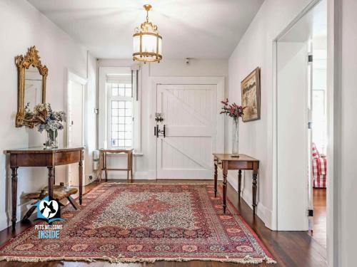a hallway with a door and a rug at Summer Lodge-Esplanade frontage Character & charm in Victor Harbor