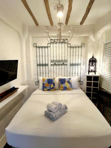 a bedroom with a bed with a towel on it at Lugar Bonito Hotel in Boracay