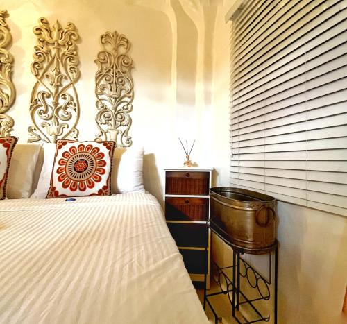 a bedroom with a bed and a table and a window at Lugar Bonito Hotel in Boracay