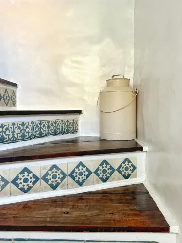 a staircase with blue and white tiles and a pot at Lugar Bonito Hotel in Boracay