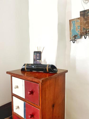 a telephone on a dresser with a cell phone on it at Lugar Bonito Hotel in Boracay
