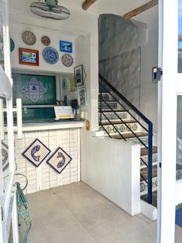 a staircase in a room with plates on the wall at Lugar Bonito Hotel in Boracay