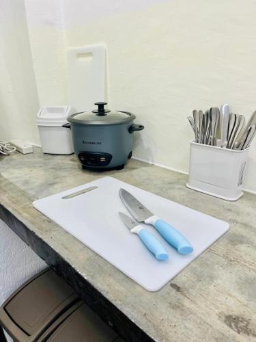 a cutting board with a knife and a pot on a counter at Lugar Bonito Hotel in Boracay