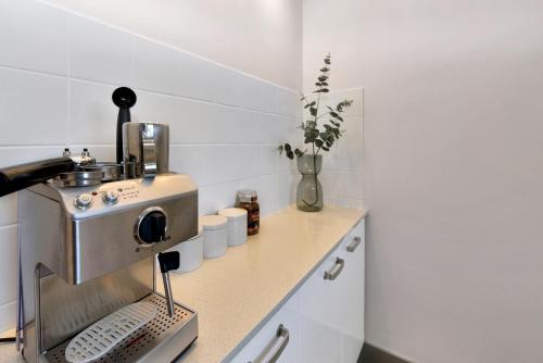 a kitchen with a coffee machine on a counter at Blissful Silver Sands Retreat - Aldinga Beach - C21 SouthCoast Holidays in Aldinga Beach