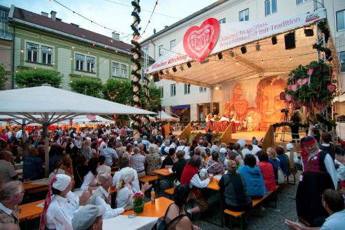 a large crowd of people sitting at tables at an event at Wellness Landhaus Parth in Ossiach