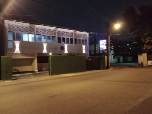 a building on a street at night with a street light at Grand Villa Wellawatta in Colombo