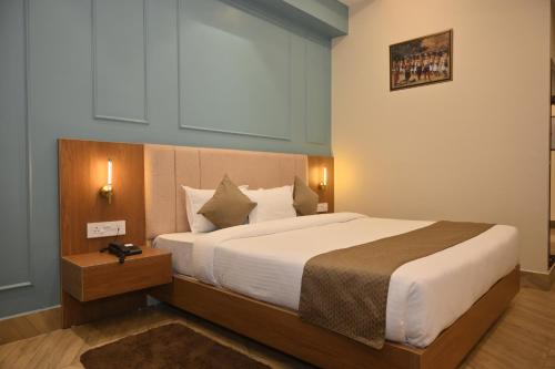a bedroom with a large bed in a room at Arunachal Bhawan in Tinsukia