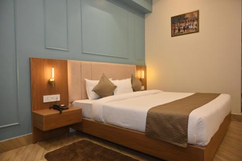 a bedroom with a large bed in a room at Arunachal Bhawan in Tinsukia
