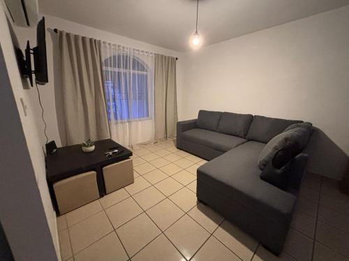 a living room with a couch and a table at Casa Montebello in Los Mochis