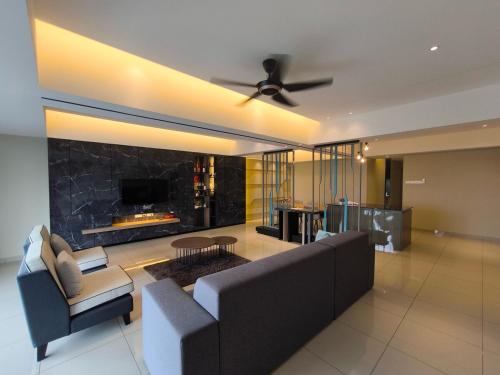 a living room with a couch and a fireplace at Venus Home Retreat - Pool,Gym,Playground,Rooftop Garden View in Kampong Lumut Kiri