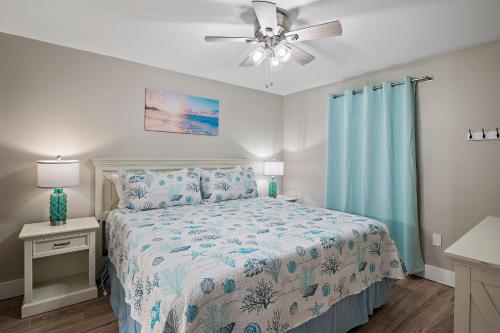 a bedroom with a bed and a ceiling fan at Pelican Beach Resort Destin in Destin