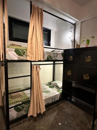 a room with two bunk beds and a dresser at Echo Koh Tao Hostel & Diving in Koh Tao
