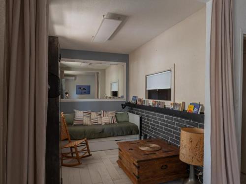 a living room with a couch and a table at Appartement RDC rénové, 4 pers, climatisation - FR-1-475-209 in Saintes-Maries-de-la-Mer