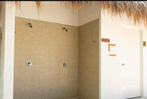 a corner of a room with a bathroom with a shower at Selva escondida in Puerto Morelos