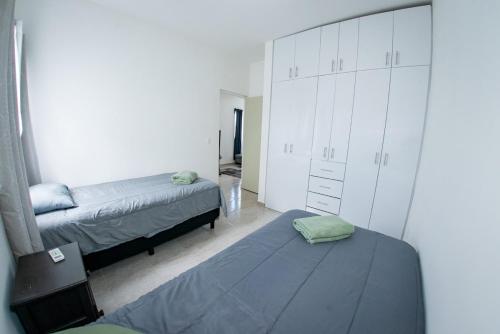 a bedroom with two beds and a dresser at Selva escondida in Puerto Morelos