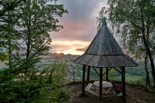 a group of people sitting in a gazebo at Wellness Landhaus Parth in Ossiach