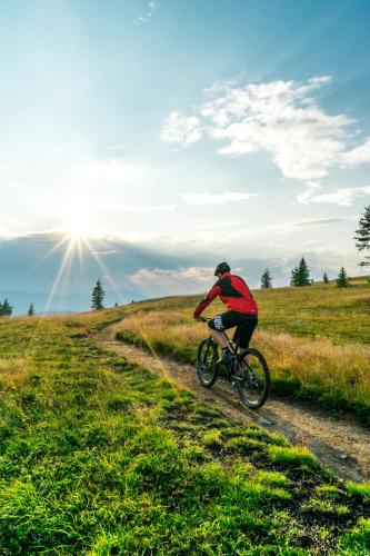 a man riding a bike down a dirt road at Wellness Landhaus Parth in Ossiach