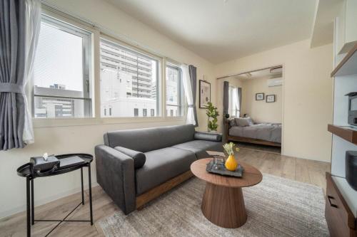 a living room with a couch and a table at Court Villa Sapporo 503 in Sapporo