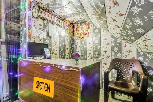 an office with a desk and a chair in a room at SPOT ON Hotel Aman Palace in Bhopal