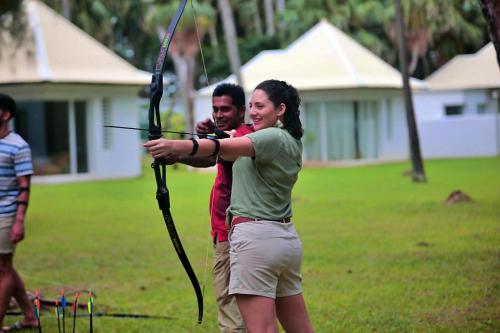 a man and a woman holding a bow and arrow at Andrea Lodges in Souillac