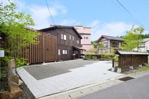 an empty parking lot in front of some buildings at うり房旅館仲通り うら房 in Kusatsu