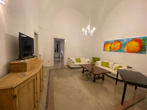 a living room with a couch and a tv at dimora la casa del melograno racale in Racale