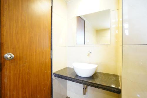 a bathroom with a sink and a mirror on a counter at Shyanu Lords Eco Inn Airoli-Near Mindspace in Navi Mumbai