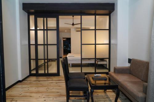 a living room with a couch and a table at Hotel Sun Shine Inn in Mumbai