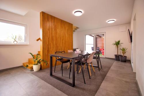 a dining room with a table and chairs at Vila sauna Plzeň apartmány Plzeň Zbůch in Zbŭch