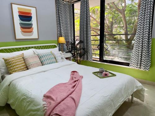 a bedroom with a bed with a blanket on it at Modern 2 BR Bandra Trendy Location in Mumbai