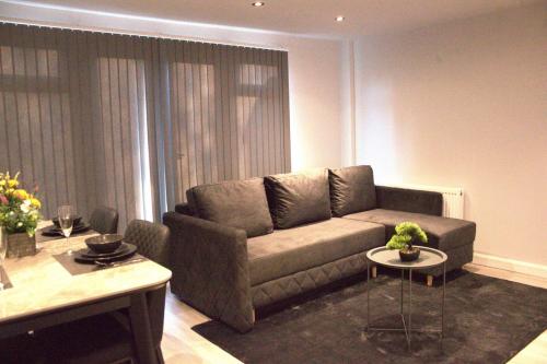 a living room with a couch and a table at Luxury 3 bedroom house in Harlow, Essex in Harlow