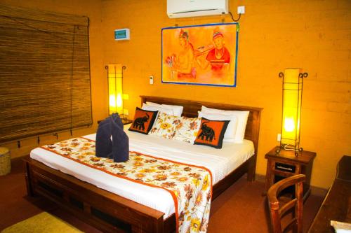 a bedroom with a bed in a room with at Lotus Eco Villa in Sigiriya