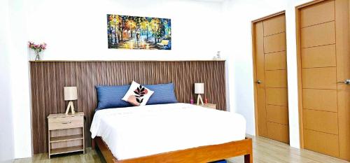 a bedroom with a bed and a painting on the wall at Casa Mel Mar Luxurious 3BR 3FullBR Villa with Pool in Panglao