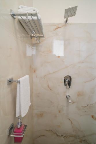 a bathroom with a marble shower with a sink at Hotel The Hidden Door-Near Jaipur Airport in Jaipur