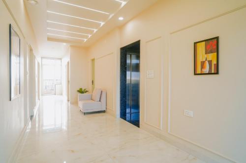 a hallway with a couch and a chair in a building at Hotel The Hidden Door-Near Jaipur Airport in Jaipur