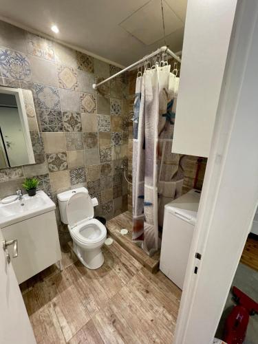a bathroom with a toilet and a sink at Seaside Escape in Athens