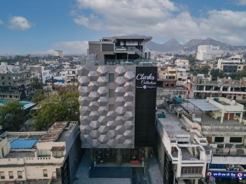 a building with a sign on it in a city at Clarks Collection Grand Sapphire Ajmer in Ajmer