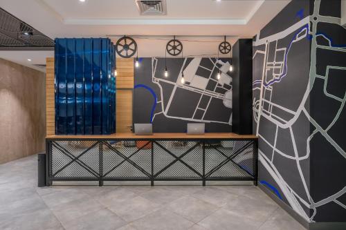 a room with a wall with a painting on it at Holiday Inn Express Greater Noida Knowledge Park by IHG in Greater Noida